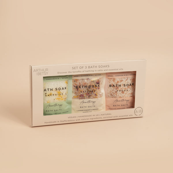 A pack of three Arthur Betsy aromatherapy bath soaks with green and pink labeling, presented in a light-colored box.