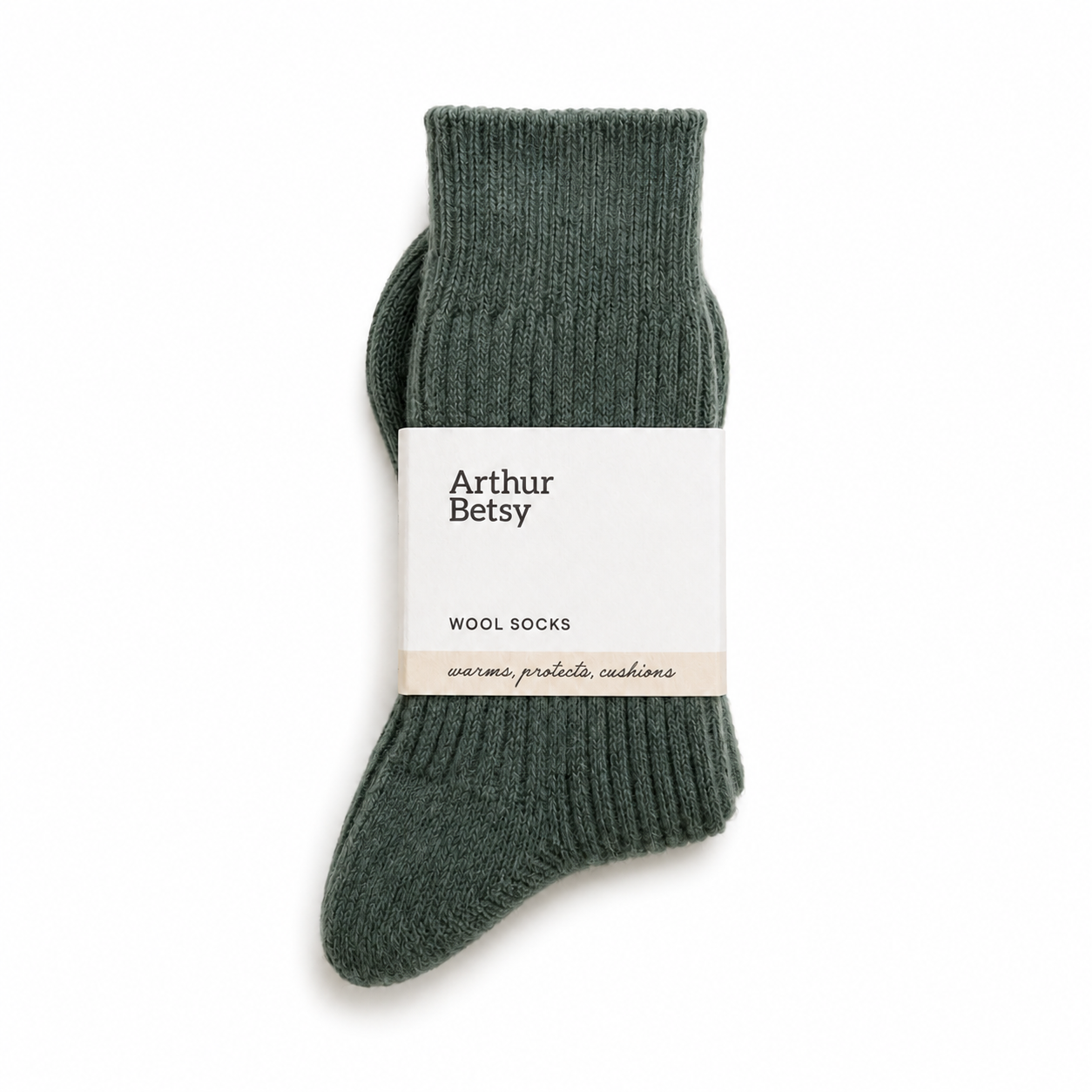 A pair of ribbed knit wool socks in a muted dark green, wrapped with a white paper band labeled 'Arthur Betsy'. Arthur Betsy luxury alpaca wool socks in Nordic Pine green, made with an 80% alpaca wool blend for warmth, softness and everyday comfort.